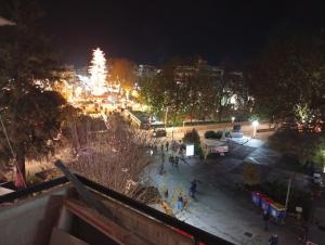a view of a city at night with a christmas tree at River Palace Suite in Tríkala