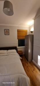 a bedroom with a bed and a window at Dartford Haven in Dartford