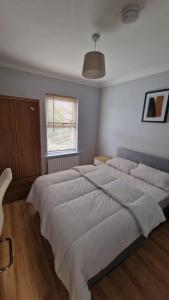 a bedroom with a large bed and a window at Dartford Haven in Dartford