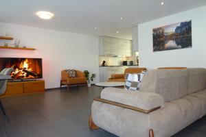 a living room with a couch and a fireplace at The Golf apartments in Interlaken