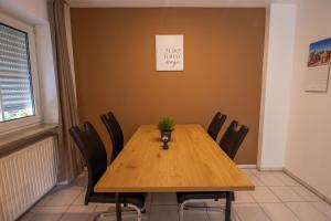 een conferentieruimte met een houten tafel en stoelen bij Ferienwohnung Josi in Ebermannstadt