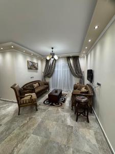 a living room with two couches and a table at Privado Modern Apartment Garden View B11 Group114 2BR in Madinaty