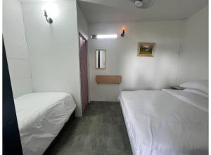 a small room with two beds and a window at OYO 91261 Thebukit, Langkawi in Kuah +31 photos