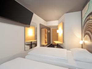 Postel nebo postele na pokoji v ubytování B&B HOTEL Berlin Genshagen-Nord + 19 fotografií