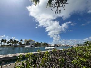 a view of a river with boats in the water at Studio moderne à Saint-François, 38 m² avec piscine in Saint-François +7 photos