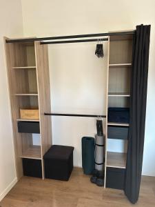 a room with a closet with a curtain and shelves at Maison avec jardin, wifi, parking, vidéo projecteur in Tulle