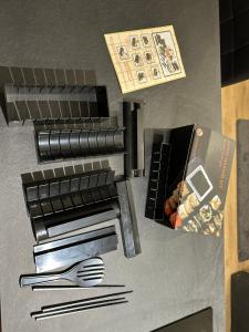 a model of a kitchen with utensils on a table at Maison avec jardin, wifi, parking, vidéo projecteur in Tulle