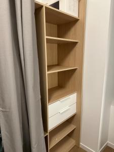 a closet with wooden shelves and a curtain at Maison avec jardin, wifi, parking, vidéo projecteur in Tulle +35 photos