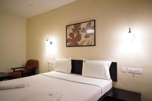 Ένα ή περισσότερα κρεβάτια σε δωμάτιο στο Wynad Hotel