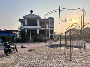 a motorcycle parked in front of a building at R D Palace and Resort in Bhauli