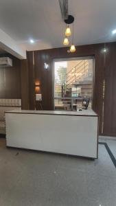 a reception desk in a room with a staircase at R D Palace and Resort in Bhauli