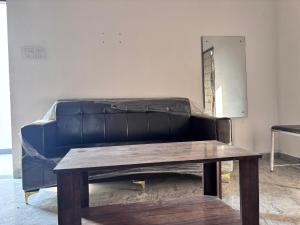 a blue couch with a table in a room at R D Palace and Resort in Bhauli +21 photos