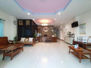 a large living room with tables and a couch at บ้านในฝัน เชียงคาน in Chiang Khan
