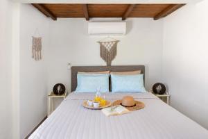 a bed with a hat and a tray of food on it at Triopetra Green Dream in Triopetra +33 photos