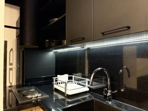 a kitchen with a sink and a faucet at Amine Apart-Hotel by Stayinn in Beirut +282 photos