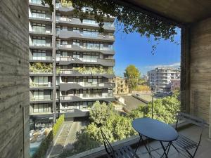 a balcony with a table and a building at Amine Apart-Hotel by Stayinn in Beirut