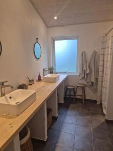 a bathroom with a sink and a large wooden counter at Summerhouse in Ulvshale, Møn in Stege +14 photos