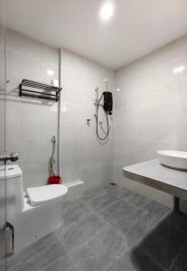 a bathroom with a toilet and a sink at Grace Homestay Taiping in Taiping