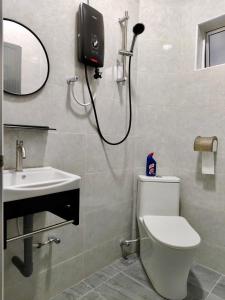 a bathroom with a shower and a toilet and a sink at Grace Homestay Taiping in Taiping +11 photos