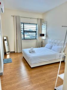 a bedroom with a bed with a teddy bear on it at EQAMEL Homestay in Sandakan +21 photos