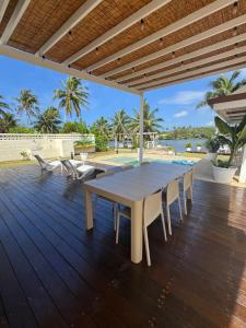 a wooden deck with a table and chairs on it at Villa Hana'iki in Paui