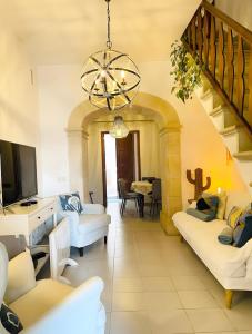 a living room with white furniture and a chandelier at Sant Miquel in Campanet