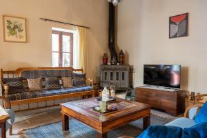 a living room with a couch and a coffee table at Villa Monti Cozy Yard & BBQ Perfect for Families & Friends in Kato Lefkara