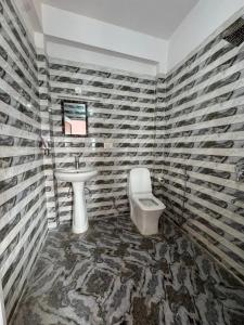 a bathroom with a sink and a toilet at Happy Homes by Yoga & Smiles, Upper Tapovan in Rishīkesh