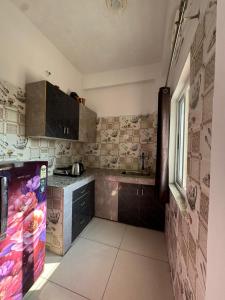a kitchen with a refrigerator and a sink in it at Happy Homes by Yoga & Smiles, Upper Tapovan in Rishīkesh
