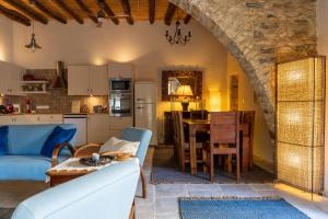 a living room with a couch and a table at Villa Monti Cozy Yard & BBQ Perfect for Families & Friends in Kato Lefkara