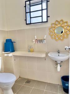 a bathroom with a toilet and a sink at EQAMEL Homestay in Sandakan +25 photos