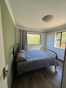 a bedroom with a bed and a window in a room at Sea and Vlei on Disa in Bettyʼs Bay