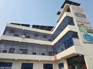 a building with solar panels on the side of it at Hotel O by OYO Radha Raman Guest House in Rait +30 photos