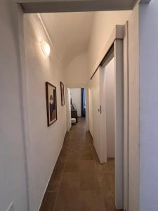 a hallway with white walls and a tile floor at Chez Gabry in Sanremo