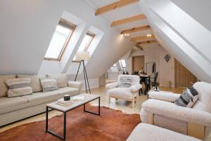 a living room with a couch and chairs and a table at Apartamenty SKI Apartments, Odkryj-Bialke in Białka Tatrzańska