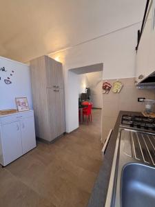 a small kitchen with a counter and a table at Chez Gabry in Sanremo