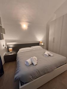 a bedroom with a bed with two towels on it at Chez Gabry in Sanremo +8 photos
