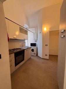 a kitchen with a sink and a stove top oven at Chez Gabry in Sanremo