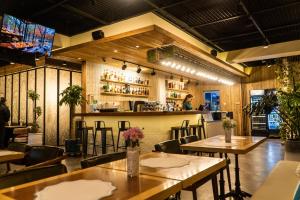 a restaurant with tables and chairs and a bar at Tanan Center Serviced Apartments in Ulaanbaatar