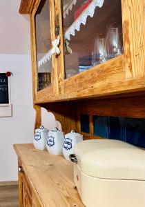 a wooden counter with cups and a wooden cabinet at Ferienwohnung Im Weingewölbe in Staufen im Breisgau +29 photos