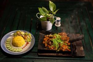 a table with a plate of food and a plate of food at Wild Monkey Jungle Villa - 4 Bedroom Villa in Unawatuna