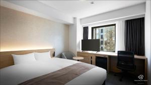 Un pat sau paturi într-o cameră la Daiwa Roynet Utsunomiya