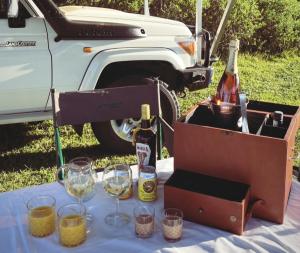a table with two bottles of wine and glasses at Zambezi Dream Cruiser in Victoria Falls