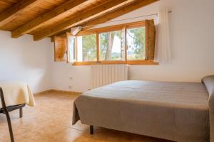 a bedroom with a bed and a window at Apartamentos Turísticos San Cristóbal by Bossh! Hotels in Cuenca