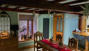 a dining room with a table with a red cloth on it at The Old Stables in Fort Augustus