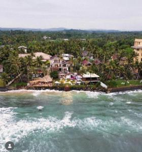 an aerial view of a resort from the water at Kabalana Surf Hostel in Ahangama