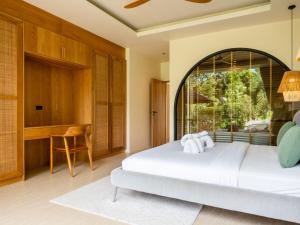 a bedroom with a bed and a large window at Homey 2Br Villa Apricot Close to Beach Sea View in Plai Laem +24 photos
