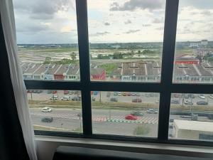 a window with a view of a parking lot at AmmarLeen Guest Suite in Kota Bharu