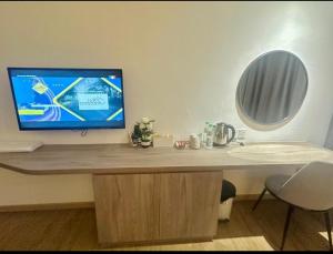 a desk with a computer monitor on top of it at AmmarLeen Guest Suite in Kota Bharu