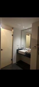 a bathroom with a sink and a mirror at AmmarLeen Guest Suite in Kota Bharu